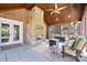 Cozy screened porch with stone fireplace and seating area at 6049 Bluebird Hill Ln, Weddington, NC 28104