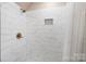 Large walk-in shower with marble tile and built-in niche at 6049 Bluebird Hill Ln, Weddington, NC 28104