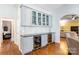 Built-in wet bar with wine cooler and glass-front cabinetry at 6049 Bluebird Hill Ln, Weddington, NC 28104