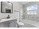 Updated bathroom with grey vanity and marble tile at 639 Harrison St, Statesville, NC 28677