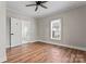 Bedroom with wood floors, ceiling fan, and en-suite bathroom at 639 Harrison St, Statesville, NC 28677