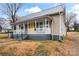 House exterior showcasing a yellow front door and gray siding at 639 Harrison St, Statesville, NC 28677