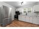 Updated kitchen, featuring stainless steel appliances and white shaker cabinets at 639 Harrison St, Statesville, NC 28677