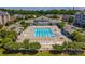 Community aerial view highlighting a large pool, clubhouse, and manicured landscaping at 6605 Central Pacific Ave # 301A, Charlotte, NC 28210