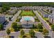 Aerial view showing a pool, clubhouse, green spaces, and residential area at 6605 Central Pacific Ave # 301A, Charlotte, NC 28210