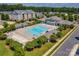 Aerial view of a pool, clubhouse, and surrounding community at 6605 Central Pacific Ave # 301A, Charlotte, NC 28210