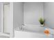 Close-up of bathtub, with chrome fixtures, tile surround, and next to a glass door shower at 6605 Central Pacific Ave # 301A, Charlotte, NC 28210