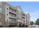 Exterior of a multi-story condo building with stacked stone and multiple balconies at 6605 Central Pacific Ave # 301A, Charlotte, NC 28210