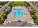 Aerial view of a sparkling community pool surrounded by lounge chairs and lush greenery at 6605 Central Pacific Ave # 301A, Charlotte, NC 28210