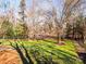 Spacious backyard with a large lawn and mature trees at 7704 Seton House Ln, Charlotte, NC 28277