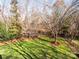 Large backyard with stepping stones and mature trees at 7704 Seton House Ln, Charlotte, NC 28277