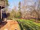 Wooded backyard with lush green grass at 7704 Seton House Ln, Charlotte, NC 28277