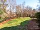 Spacious backyard with lush lawn, providing a tranquil outdoor space at 7704 Seton House Ln, Charlotte, NC 28277