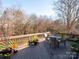 Deck with table and chairs, offering scenic wooded views at 7704 Seton House Ln, Charlotte, NC 28277