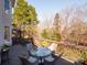 Deck with table and chairs, offering scenic wooded views at 7704 Seton House Ln, Charlotte, NC 28277