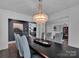 Spacious dining room with dark wood table and a statement chandelier at 7704 Seton House Ln, Charlotte, NC 28277