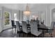 Formal dining room with a large table, gray chairs, and chandelier at 7704 Seton House Ln, Charlotte, NC 28277