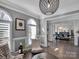 Open concept dining room with hardwood floors and chandelier; view from living room at 7704 Seton House Ln, Charlotte, NC 28277