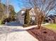 Side view of house with driveway and landscaping at 7704 Seton House Ln, Charlotte, NC 28277