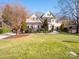 Two-story house with stucco exterior, landscaped lawn, and a two-car garage at 7704 Seton House Ln, Charlotte, NC 28277