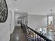 Upper hallway with hardwood floors and a view of the living area below at 7704 Seton House Ln, Charlotte, NC 28277