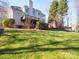 Two story house exterior with deck and stone pathway, nestled amongst trees at 7704 Seton House Ln, Charlotte, NC 28277