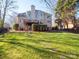 Two story house exterior with deck and stone pathway, nestled amongst trees at 7704 Seton House Ln, Charlotte, NC 28277