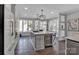 Eat-in kitchen with large island, wine fridge, and stainless steel appliances at 7704 Seton House Ln, Charlotte, NC 28277