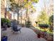 Spacious brick patio with comfortable seating, overlooking a wooded area at 7704 Seton House Ln, Charlotte, NC 28277