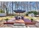 Large backyard with a deck, fire pit, storage shed, and landscaping, providing a versatile outdoor space at 7832 Winterset Dr, Charlotte, NC 28270