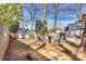 Large backyard featuring a fire pit area, deck with umbrella, and shed, offering multiple outdoor spaces at 7832 Winterset Dr, Charlotte, NC 28270