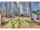 Expansive backyard featuring a well-manicured lawn, large deck, storage shed, and fire pit at 7832 Winterset Dr, Charlotte, NC 28270