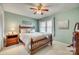 Cozy bedroom with a decorative ceiling fan and natural light from the window at 7832 Winterset Dr, Charlotte, NC 28270