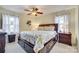 Serene bedroom with a large bed, stylish decor, and natural light from two windows at 7832 Winterset Dr, Charlotte, NC 28270