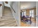 Bright dining room with hardwood floors, large windows, and an elegant chandelier at 7832 Winterset Dr, Charlotte, NC 28270