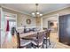 Cozy dining area with an oval table, chandelier, and view into the living spaces at 7832 Winterset Dr, Charlotte, NC 28270