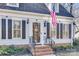 Welcoming entrance with brick steps, decorative railing, and a glass storm door at 7832 Winterset Dr, Charlotte, NC 28270