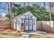 Charming backyard shed featuring decorative signage and a seating area, adding character to the outdoor space at 7832 Winterset Dr, Charlotte, NC 28270