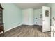 Serene bedroom with light-colored walls, wood-look floors and access to another room at 859 Accent Se Ave, Concord, NC 28025