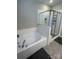 Bathroom featuring garden tub and walk-in shower at 8928 Morning Mist Rd, Charlotte, NC 28215