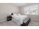 Bright bedroom featuring a comfy bed and a nightstand at 8928 Morning Mist Rd, Charlotte, NC 28215