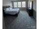 Spacious main bedroom with plush carpet and large windows at 8928 Morning Mist Rd, Charlotte, NC 28215