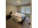 Well-lit bedroom with comfy bed and storage bench at 8928 Morning Mist Rd, Charlotte, NC 28215