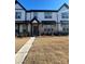 Townhouse exterior featuring a walkway and landscaping at 8928 Morning Mist Rd, Charlotte, NC 28215