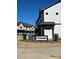 Modern two-story townhome with gray and white exterior and landscaping at 8928 Morning Mist Rd, Charlotte, NC 28215