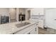 Island kitchen with granite countertops and stainless steel sink at 8928 Morning Mist Rd, Charlotte, NC 28215