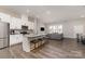 Modern kitchen with white cabinets, granite countertops, and an island with seating at 8928 Morning Mist Rd, Charlotte, NC 28215