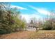 View of the house front from across a yard with bamboo at 911 Elm St, Kannapolis, NC 28081