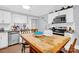 Kitchen with white cabinets, wood table and stainless steel appliances at 911 Elm St, Kannapolis, NC 28081