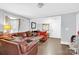 Living room with brown leather couches and a red accent chair at 911 Elm St, Kannapolis, NC 28081